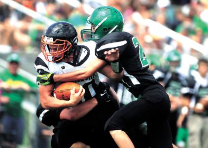 times reporter pat burk n strasburgs landry hostetler scores one of his five touchdowns at conotton valleys bryden adams helps bring him down saturday at conotton valley