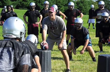 wm coach matt miller instructs his players at a practice