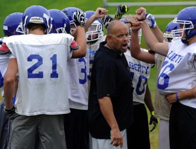 liberty coach larry luthe talks with his players