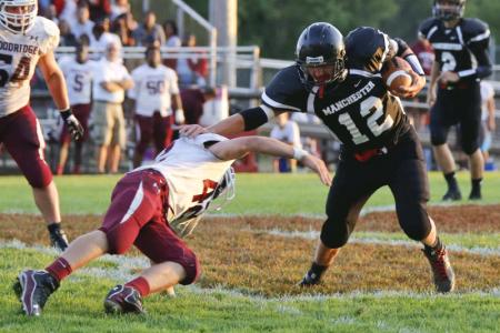 manchester high schools austin klein right fends off  woodridge high schools chris reese in the 2nd quarter in  new franklin ohio on sept 6 2013  lew stamp photography