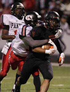 independent kevin whitlock n massillons reggie rogers hauls warrens deonte morgan into the endzone as warrens deandre merchant gives chase rogers scored in the first half after connecting with quarterback danny clark