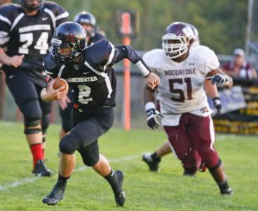 manchester quarterback pavin parks 2 scrambles from woodridge defense during week 2 of the high school of the high school football season
