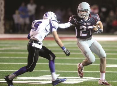 times-reporter jim cummings n dovers kyle abel stiff arms caambridges raley hayhurst in fridays game at crater stadium