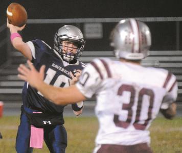 manchester valley quarterback brody coleman throws a pass in front of winters mills ryan barron thursday oct 17 in manchester