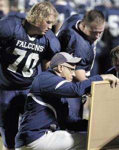 independent kevin whitlock n fairless head coach don wilson goes over a play with 70 jake mcgrath and 77  adam widder on the sidelines during the fairless tuslaw game last week