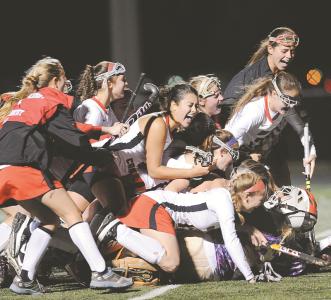 north carroll teammates pile on top of goalie melanie martin after winning their class 1a state semifinal against kent county in reisterstown wednesday nov 6 2013