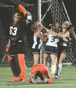 century field hockey players celebrate the winning goal during the second overtime against glenelg