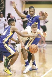 repository bob rossiter n glenoaks brandon grider is guarded at center court by timkens randee reed left and lepear toles during the first quarter