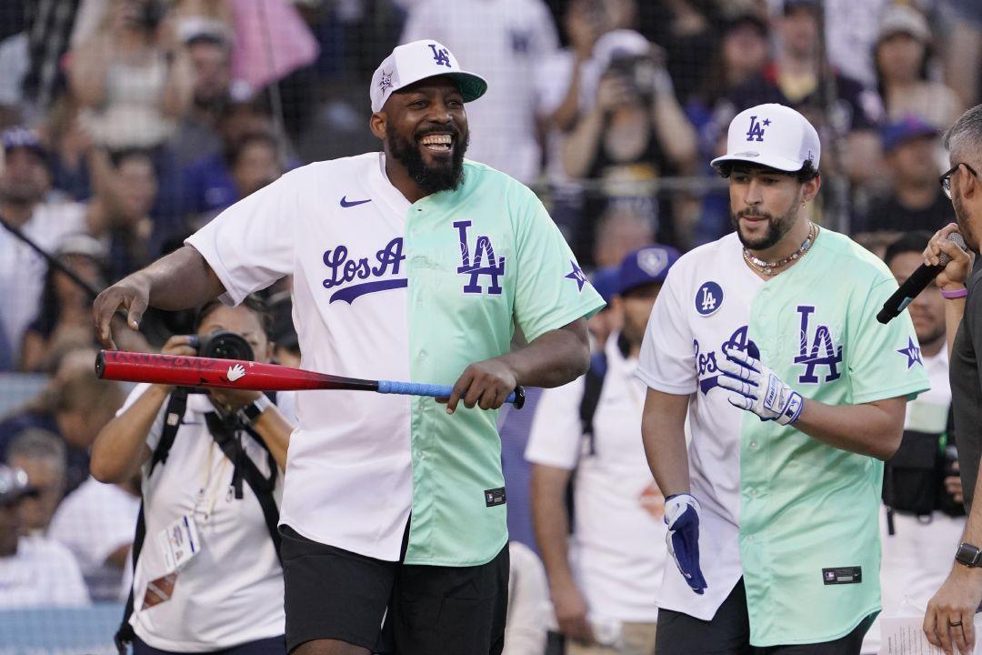 Former Major League Baseball player Vladimir Guerrero smiles next to Rapper  and Singer Bad Bunny during the MLB All Star Celebrity Softball game,  Saturday, July 16, 2022, in Los Angeles. (AP Photo/Mark