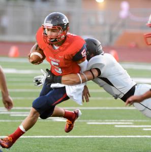 chargers quarterback marcus castillo is tackled by a rivera raiders defender during a district 32-6a match on saturday oct 4 2014 in brownsville texas ap photothe brownsville herald jason hoekema