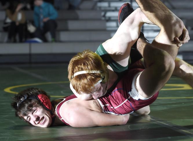 centurys brady rogers applies pressure to fsks blake romanoff during their 132-pound bout in eldersburg wednesday jan 14 2015