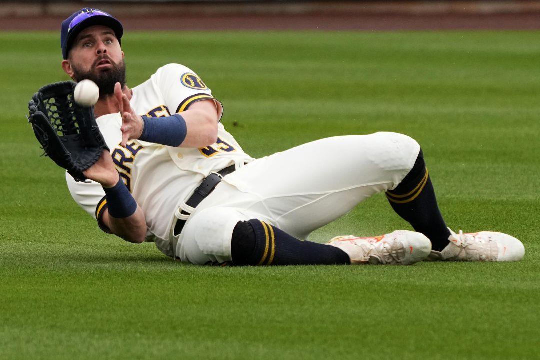 Milwaukee Brewers' Jesse Winker catches a fly ball hit by Chicago